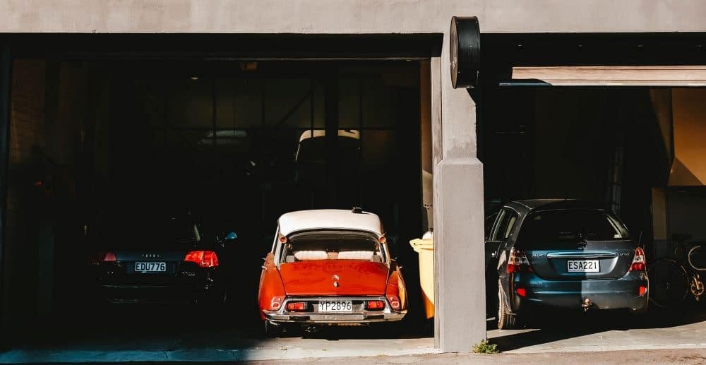 Audi, Red Vintage Sports Car, and Honda Civic Parked in Residential Garage -min