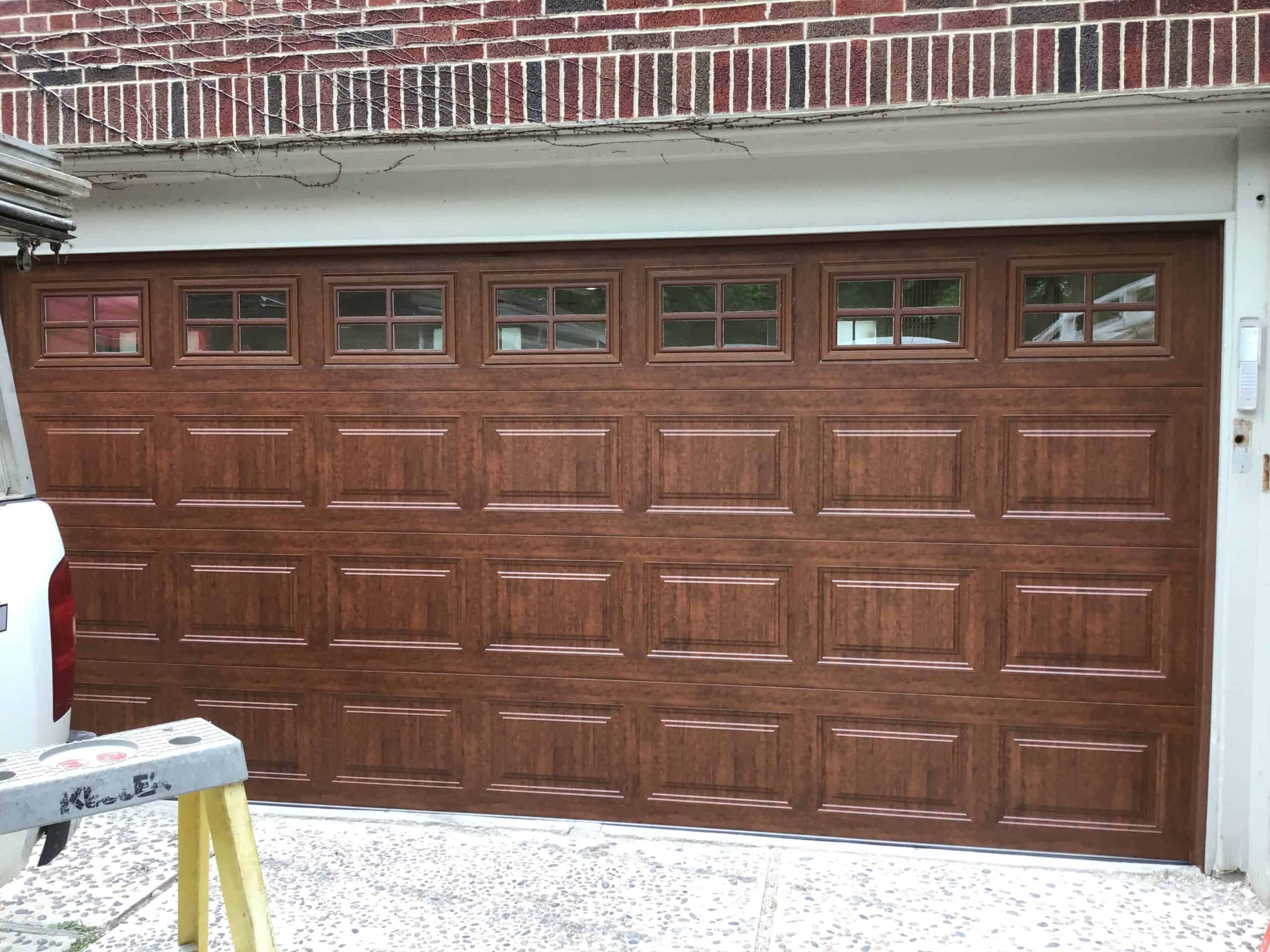 New brown wood style Cloplay garage door in Chicagoland.