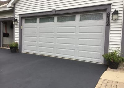 Clopay grey garage door with windows installation in Brighton, Wisconsin