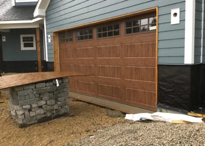 Clopay wooden garage door with windows installation in Burlington, Wisconsin