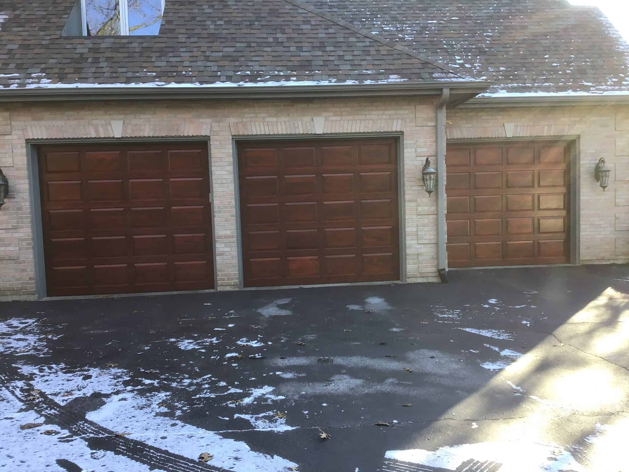 Three single Clopay wooden garage doors installation in Lake County, Illinois