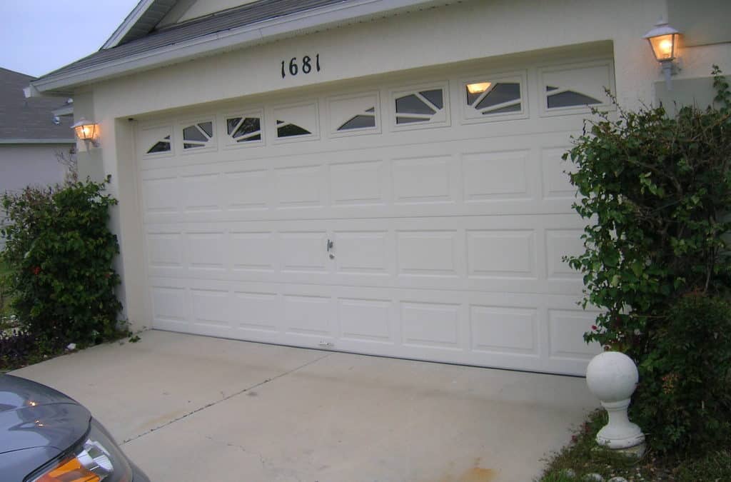 Garage door with car in the driveway