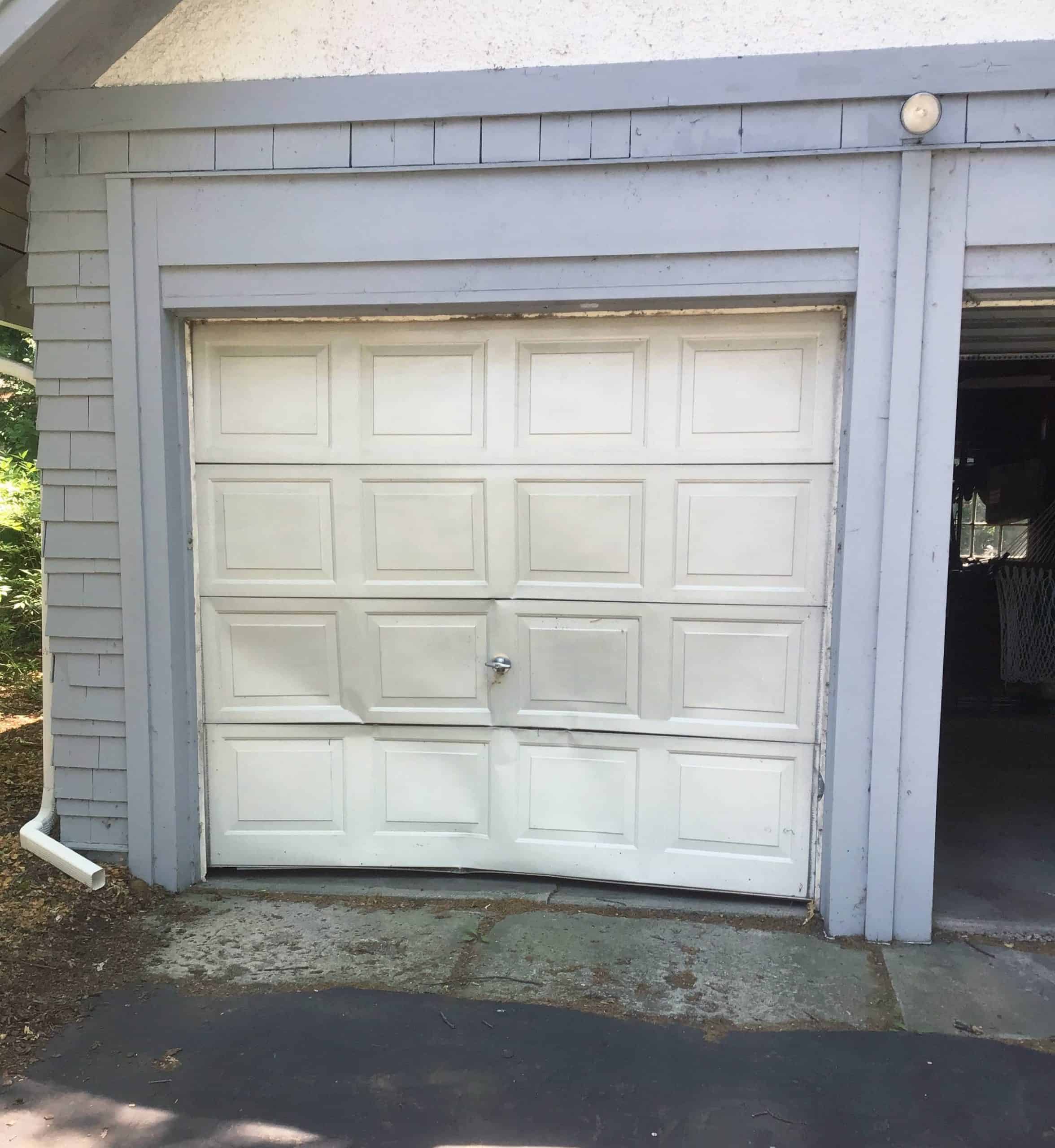 A dented garage door in need of garage door repair in Ingleside, Illinois