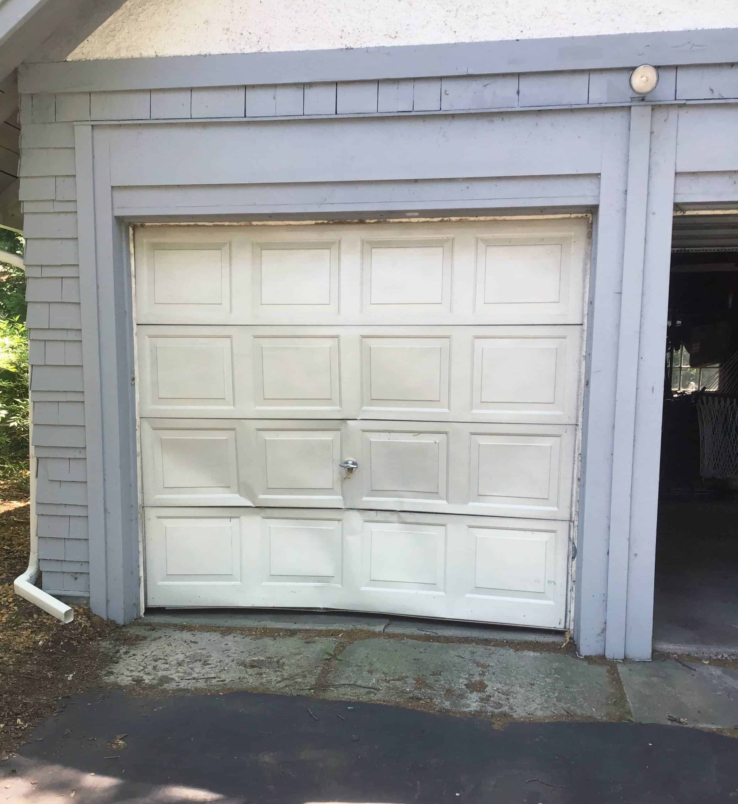 dented-garage-door-illinois A dented garage door in need of garage door repair in Ingleside, Illinois