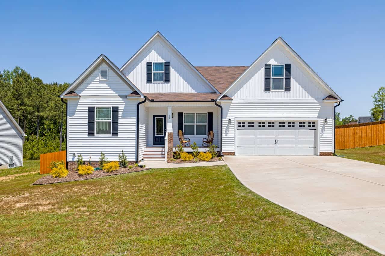 An exterior shot of a nice, suburban home with a driveway and a garage