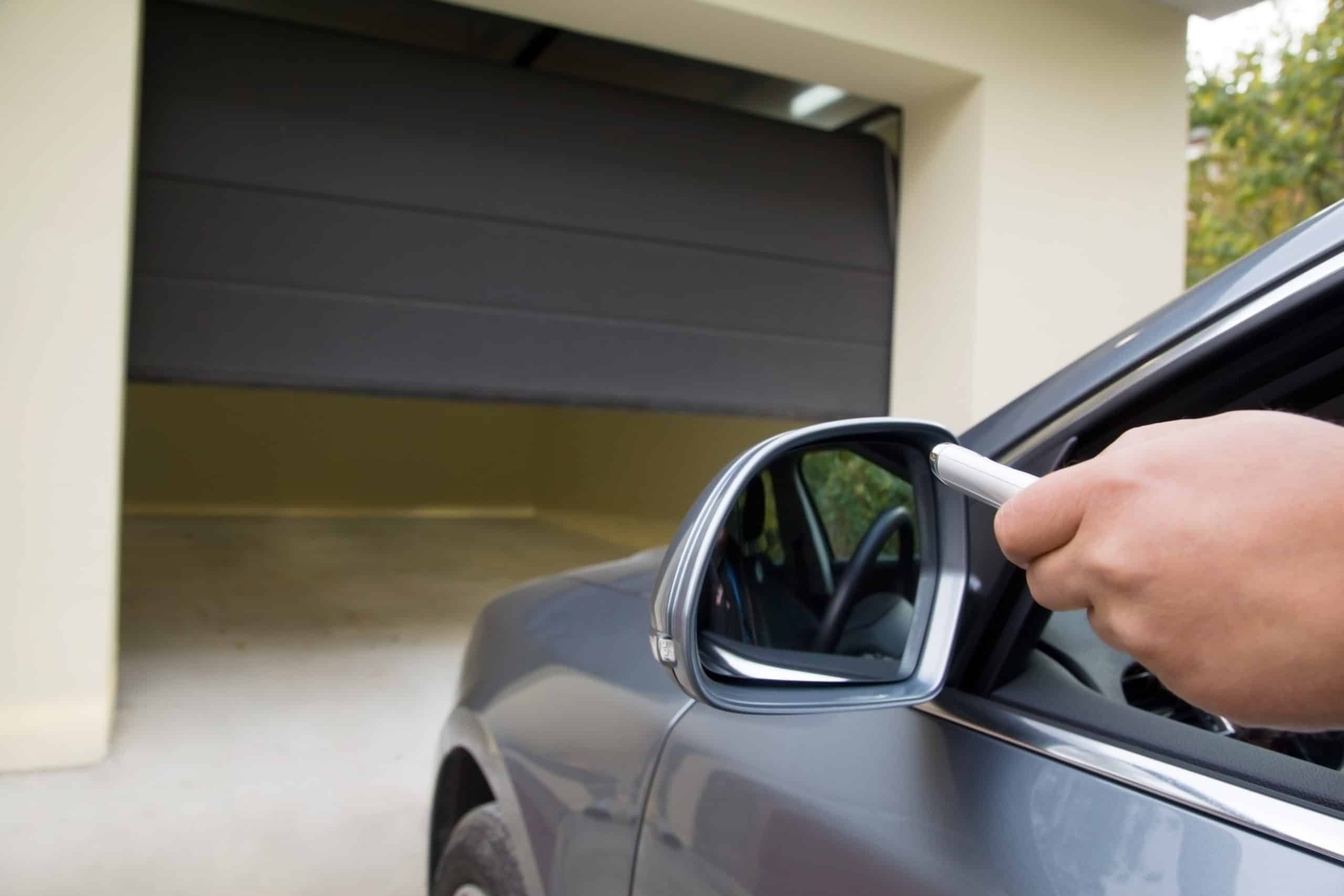 driver opens the garage with remote control opening garage door with remote from car